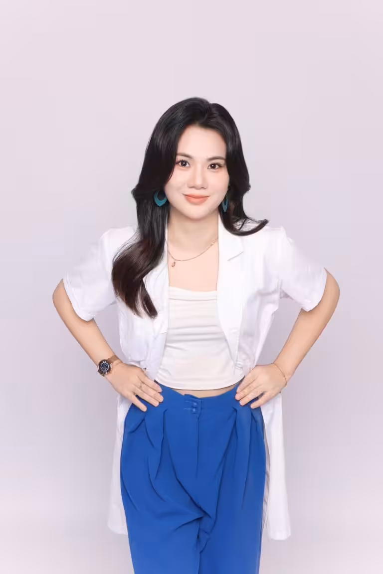 Jaceme Chuah dietitian wearing white jacket and blue pants, smiling.