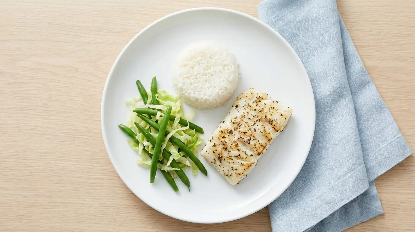 Kidney-friendly renal diet meal with fish, white rice and lower-potassium vegetables