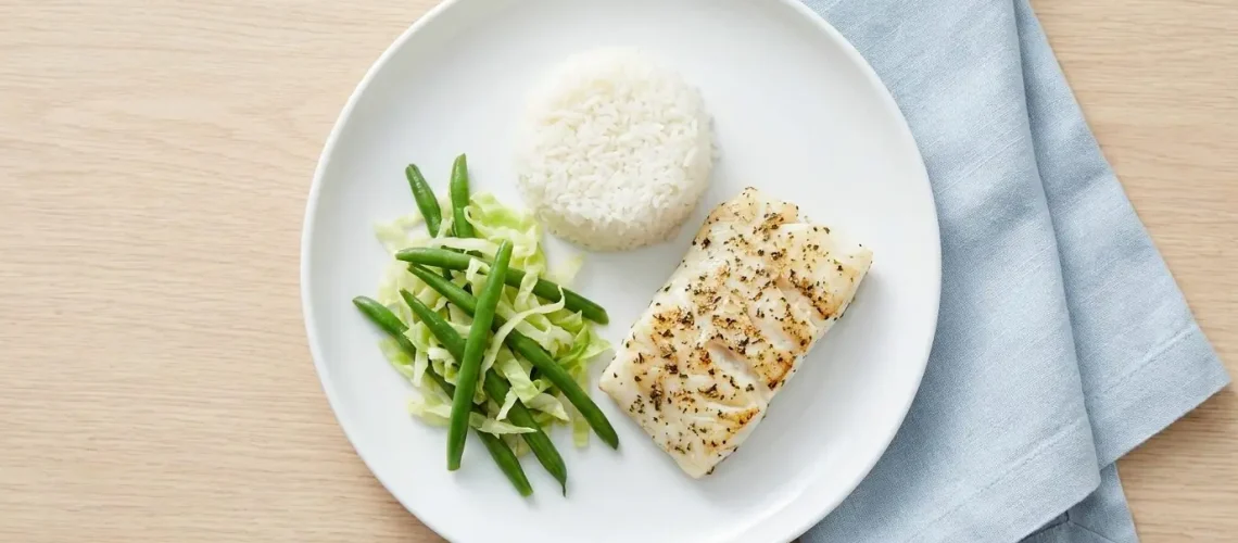 Kidney-friendly renal diet meal with fish, white rice and lower-potassium vegetables